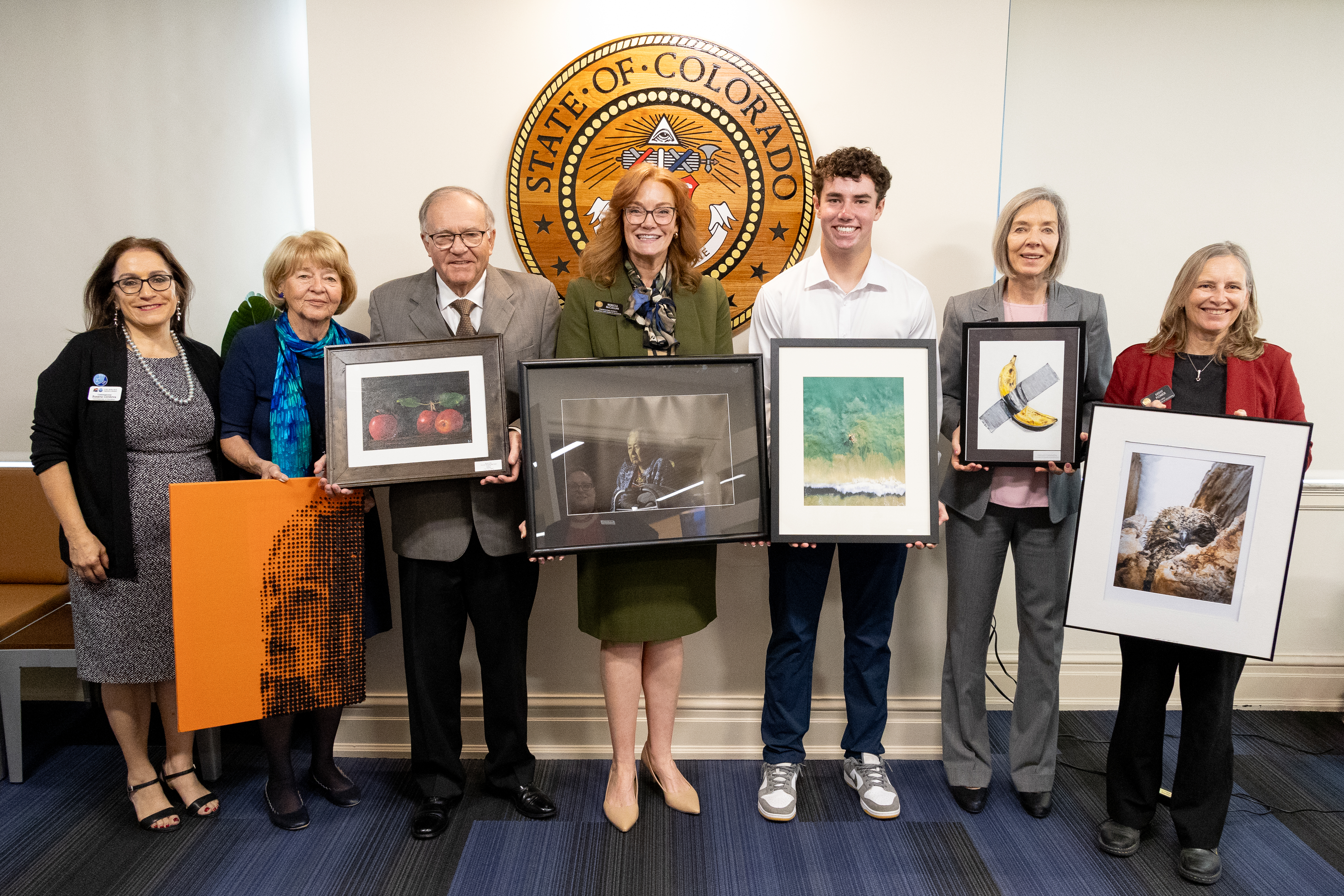 Photo of the State Board members standing with Braeden Macchia of Silver Creek High School in Saint Vrain Valley School District. Braeden's drone photo won second place in the 2024 Congressional Art Competition, and his photo will be displayed at the Stat