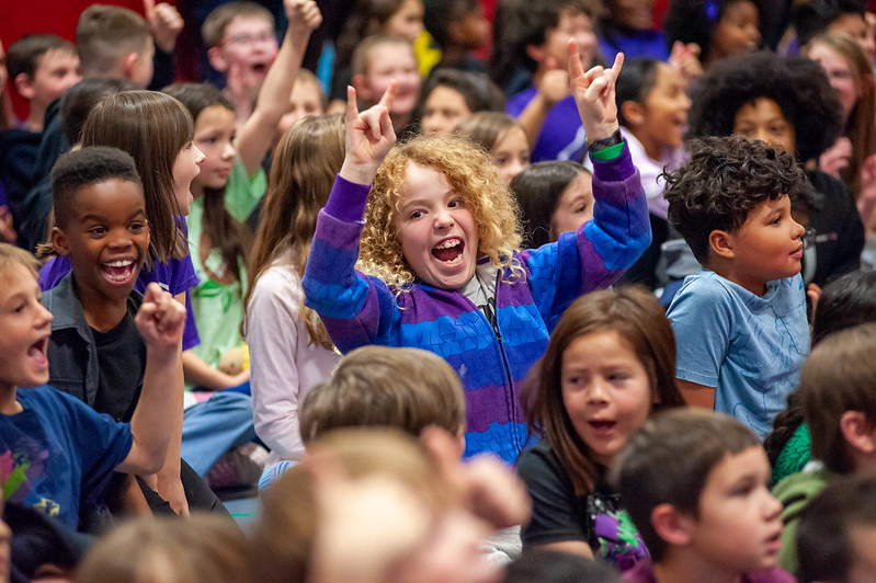 Excited student in a school assembly