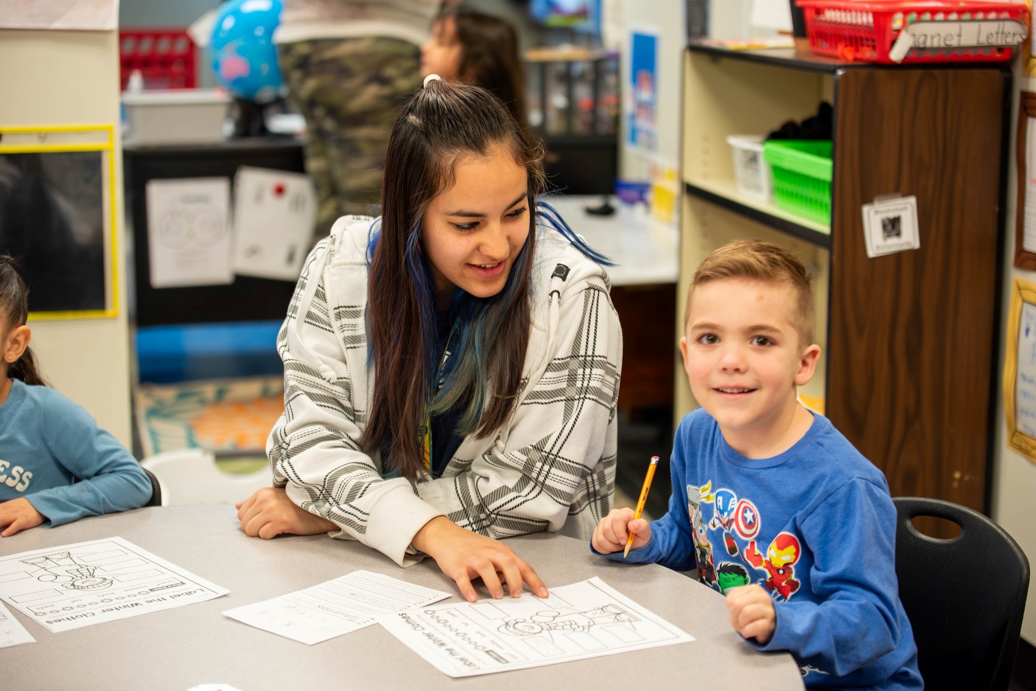 A high school student in the P-Teach program works with a student. 