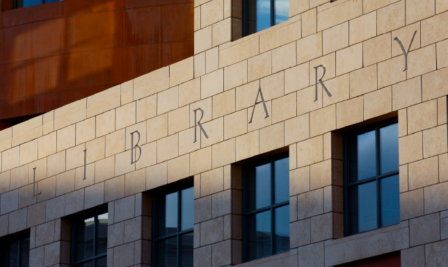 A light brick commercial building with the word 