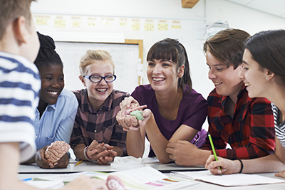 high school aged students sitting around a table